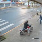 a person on a motorcycle on the sidewalk