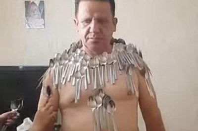 Man-balances-96-spoons-on-his-body-to-break-his-own-world-record